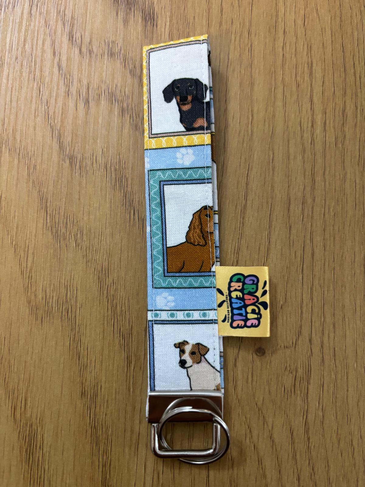 Keyring dog illustrations on a wooden surface with metal hardware