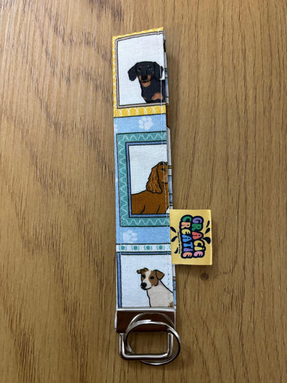 Keyring dog illustrations on a wooden surface with metal hardware