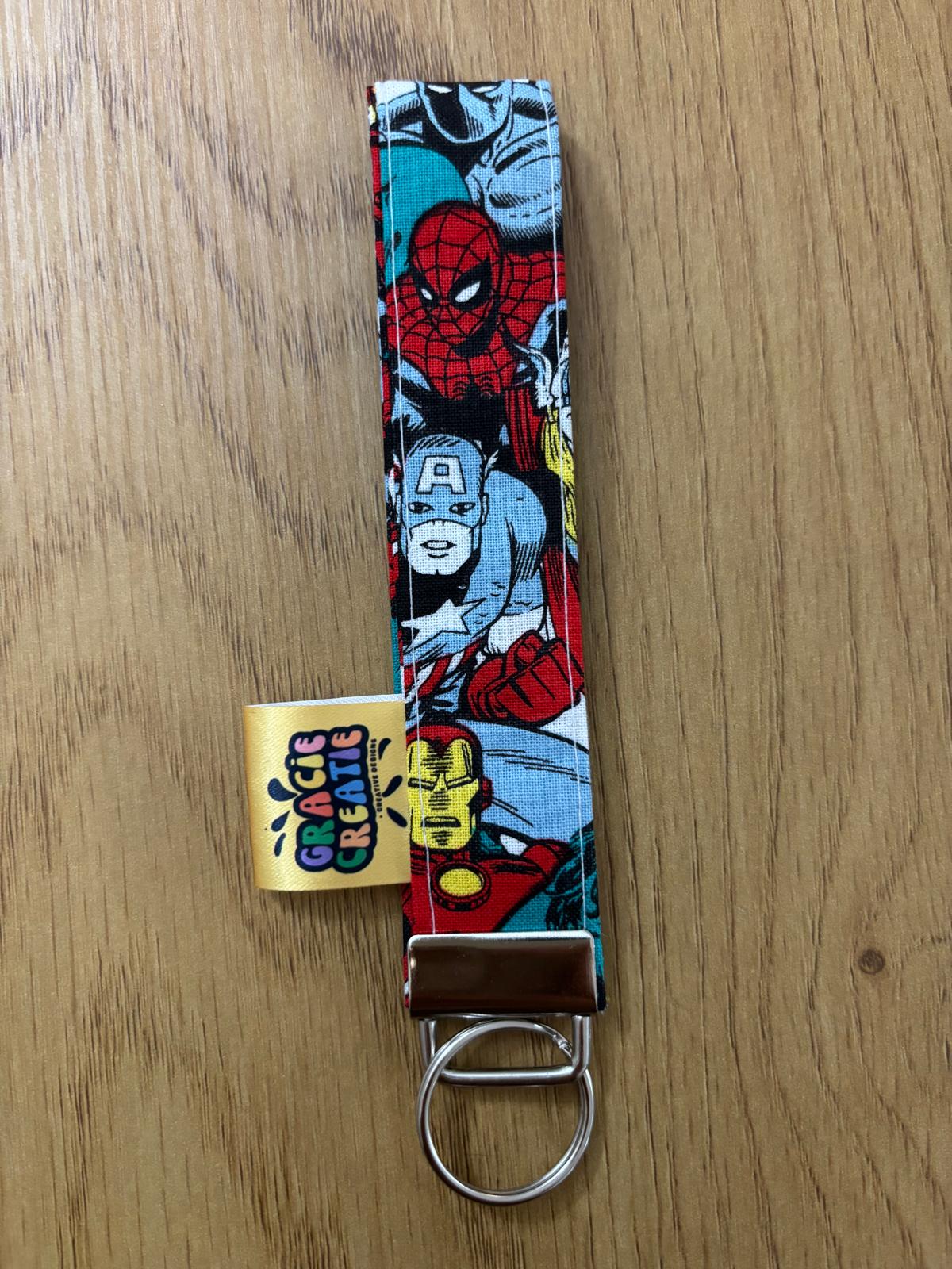 Keychain with Marvel superhero design on a wooden surface with metal hardware