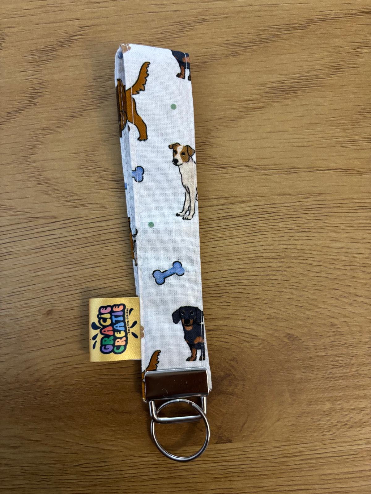 Keychain with dog pattern on a wooden surface with metal hardware